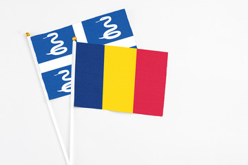 Chad and Martinique stick flags on white background. High quality fabric, miniature national flag. Peaceful global concept.White floor for copy space.