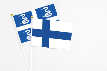 Finland and Martinique stick flags on white background. High quality fabric, miniature national...