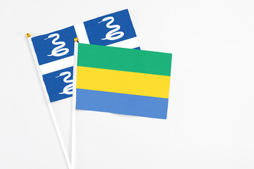 Gabon and Martinique stick flags on white background. High quality fabric, miniature national flag....