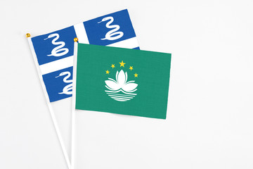 Macao and Martinique stick flags on white background. High quality fabric, miniature national flag. Peaceful global concept.White floor for copy space.