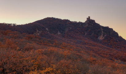 Fototapeta premium Ancient fortress on the mountain autumn slopes