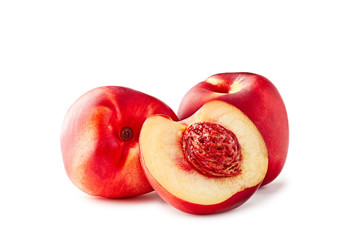 Two and slice of half nectarines on white background