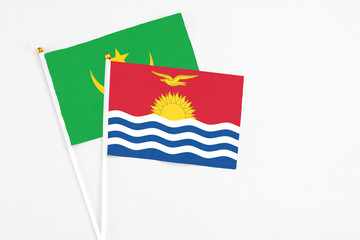 Kiribati and Mauritania stick flags on white background. High quality fabric, miniature national flag. Peaceful global concept.White floor for copy space.