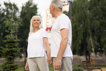 Naklejka premium Gladsome lady smiling to her husband stock photo
