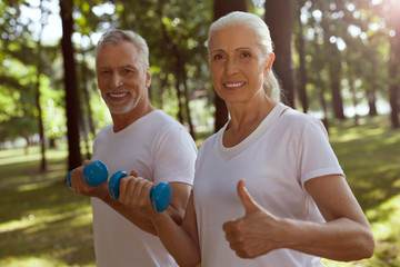 Mature couple enjoying weight exercises stock photo