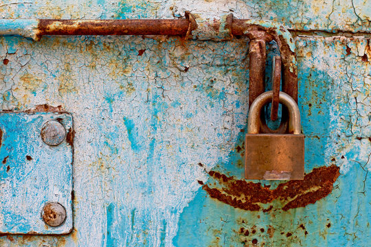 door lock for key closing, keyhole, hasp bolt. Collection of old vintage retro locks on the textured colored door. Close-up