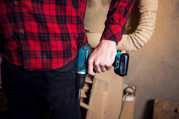 Close up view of man holding drill