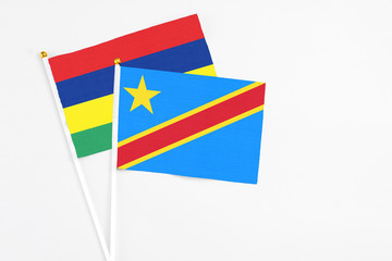 Congo and Mauritius stick flags on white background. High quality fabric, miniature national flag. Peaceful global concept.White floor for copy space.