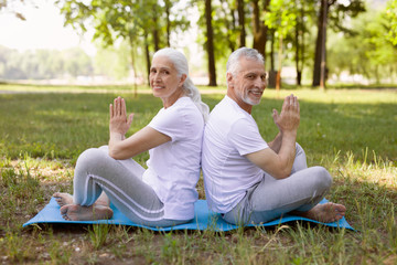 Friendly couple doing meditation together stock photo