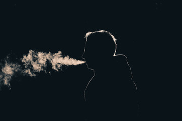 Sillouette of a smoking man in low key