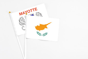 Cyprus and Mayotte stick flags on white background. High quality fabric, miniature national flag. Peaceful global concept.White floor for copy space.