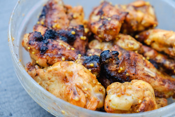 Grilled chicken wings in plate.