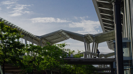 Woman walking over a pedestrian bridge at the airport
