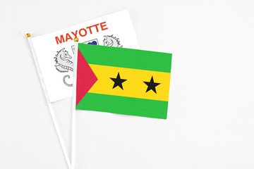 Sao Tome And Principe and Mayotte stick flags on white background. High quality fabric, miniature national flag. Peaceful global concept.White floor for copy space.