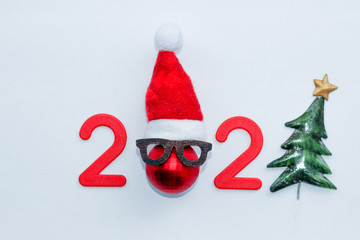 new year 2020. red numbers and Christmas toys on the Christmas tree in the form of balls, minimalism, space for text. top view