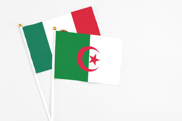 Algeria and Mexico stick flags on white background. High quality fabric, miniature national flag. Peaceful global concept.White floor for copy space.