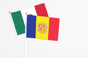 Andorra and Mexico stick flags on white background. High quality fabric, miniature national flag. Peaceful global concept.White floor for copy space.