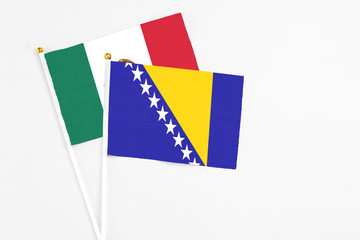 Bosnia Herzegovina and Mexico stick flags on white background. High quality fabric, miniature national flag. Peaceful global concept.White floor for copy space.