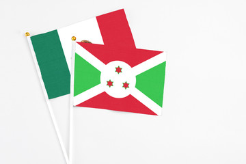 Burundi and Mexico stick flags on white background. High quality fabric, miniature national flag. Peaceful global concept.White floor for copy space.