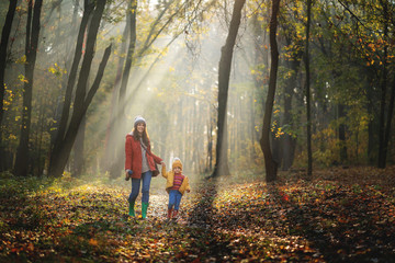 Fototapeta premium Mother and little daughter playing together in a park