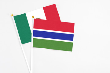 Gambia and Mexico stick flags on white background. High quality fabric, miniature national flag. Peaceful global concept.White floor for copy space.