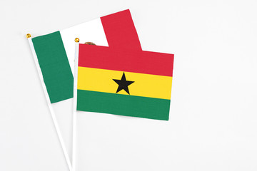 Ghana and Mexico stick flags on white background. High quality fabric, miniature national flag. Peaceful global concept.White floor for copy space.