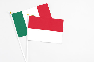 Indonesia and Mexico stick flags on white background. High quality fabric, miniature national flag. Peaceful global concept.White floor for copy space.