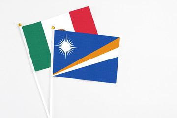 Marshall Islands and Mexico stick flags on white background. High quality fabric, miniature national flag. Peaceful global concept.White floor for copy space.