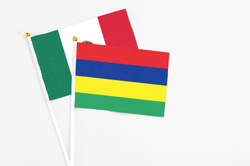Mauritius and Mexico stick flags on white background. High quality fabric, miniature national flag. Peaceful global concept.White floor for copy space.