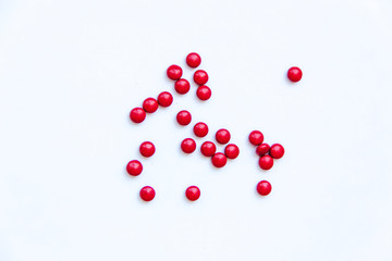 Red pills on white background