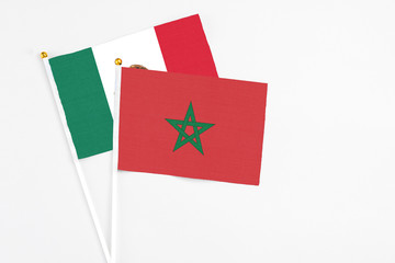 Morocco and Mexico stick flags on white background. High quality fabric, miniature national flag. Peaceful global concept.White floor for copy space.