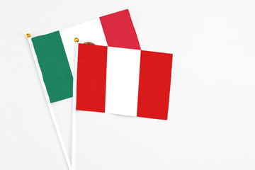 Peru and Mexico stick flags on white background. High quality fabric, miniature national flag. Peaceful global concept.White floor for copy space.