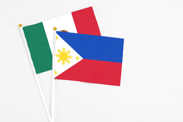 Philippines and Mexico stick flags on white background. High quality fabric, miniature national flag. Peaceful global concept.White floor for copy space.