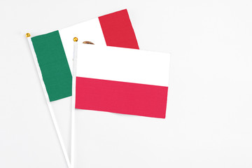 Poland and Mexico stick flags on white background. High quality fabric, miniature national flag. Peaceful global concept.White floor for copy space.