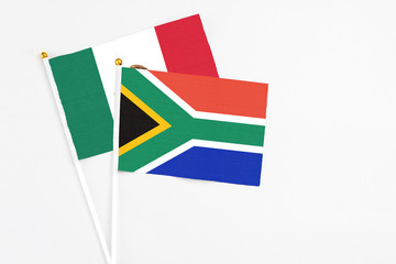 South Africa and Mexico stick flags on white background. High quality fabric, miniature national flag. Peaceful global concept.White floor for copy space.
