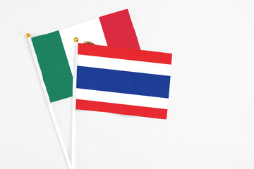 Thailand and Mexico stick flags on white background. High quality fabric, miniature national flag. Peaceful global concept.White floor for copy space.
