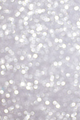 Silver defocused glitter backround with place for text.