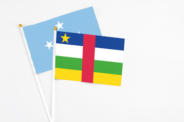 Central African Republic and Micronesia stick flags on white background. High quality fabric, miniature national flag. Peaceful global concept.White floor for copy space.