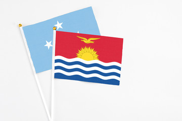 Kiribati and Micronesia stick flags on white background. High quality fabric, miniature national flag. Peaceful global concept.White floor for copy space.