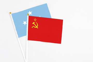 Soviet Union and Micronesia stick flags on white background. High quality fabric, miniature national flag. Peaceful global concept.White floor for copy space.