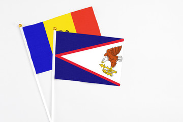 American Samoa and Moldova stick flags on white background. High quality fabric, miniature national...