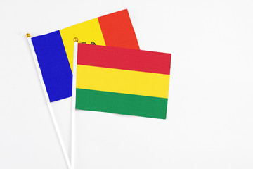 Bolivia and Moldova stick flags on white background. High quality fabric, miniature national flag. Peaceful global concept.White floor for copy space.