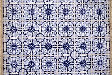 Wall with traditional Portuguese decor tiles azulezhu in blue tones.