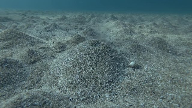 An underground source of fresh water comes out from the sandy seabed and mixes with sea water. Mediterranean Sea, Rhodes island, Greece