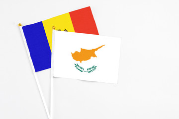 Cyprus and Moldova stick flags on white background. High quality fabric, miniature national flag. Peaceful global concept.White floor for copy space.