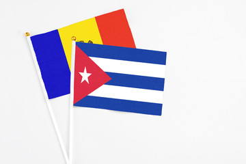 Cuba and Moldova stick flags on white background. High quality fabric, miniature national flag. Peaceful global concept.White floor for copy space.