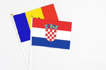 Croatia and Moldova stick flags on white background. High quality fabric, miniature national flag. Peaceful global concept.White floor for copy space.