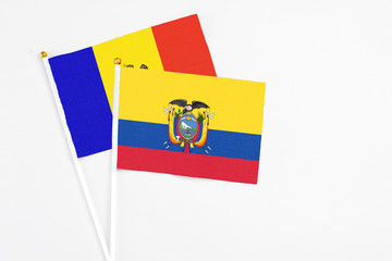 Fototapeta premium Ecuador and Moldova stick flags on white background. High quality fabric, miniature national flag. Peaceful global concept.White floor for copy space.