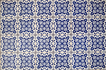 Wall with traditional Portuguese decor tiles azulezhu in blue tones.