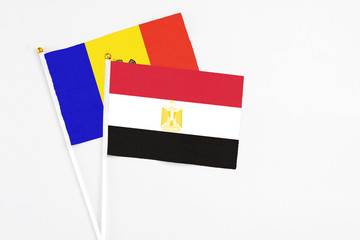 Egypt and Moldova stick flags on white background. High quality fabric, miniature national flag. Peaceful global concept.White floor for copy space.